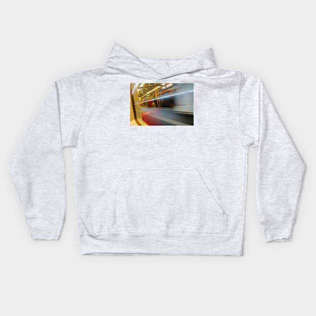 Commuters or passengers blurred in motion through window of passing train Kids Hoodie by brians101